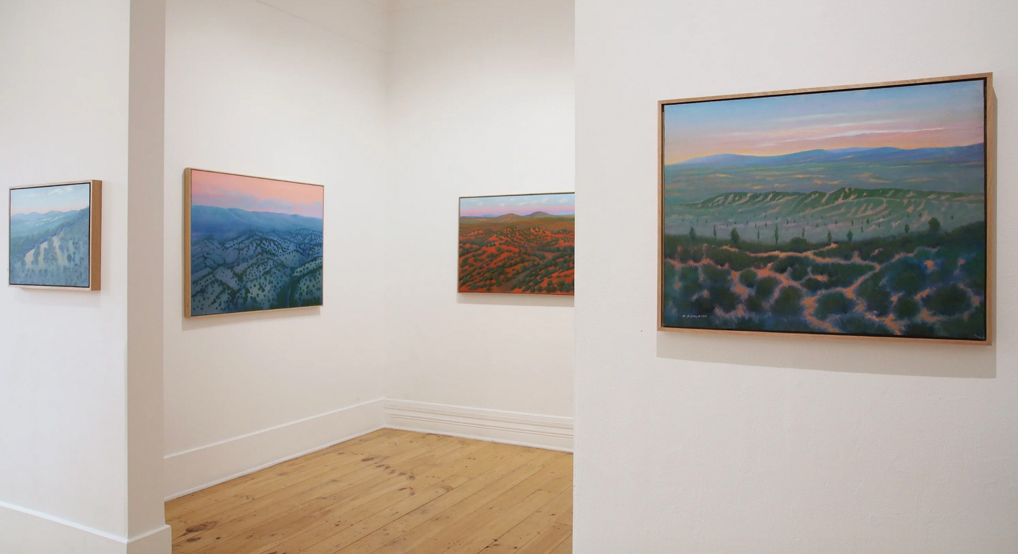 Clive’s paintings on white gallery walls, Morning Light, Outback S.A. on the right